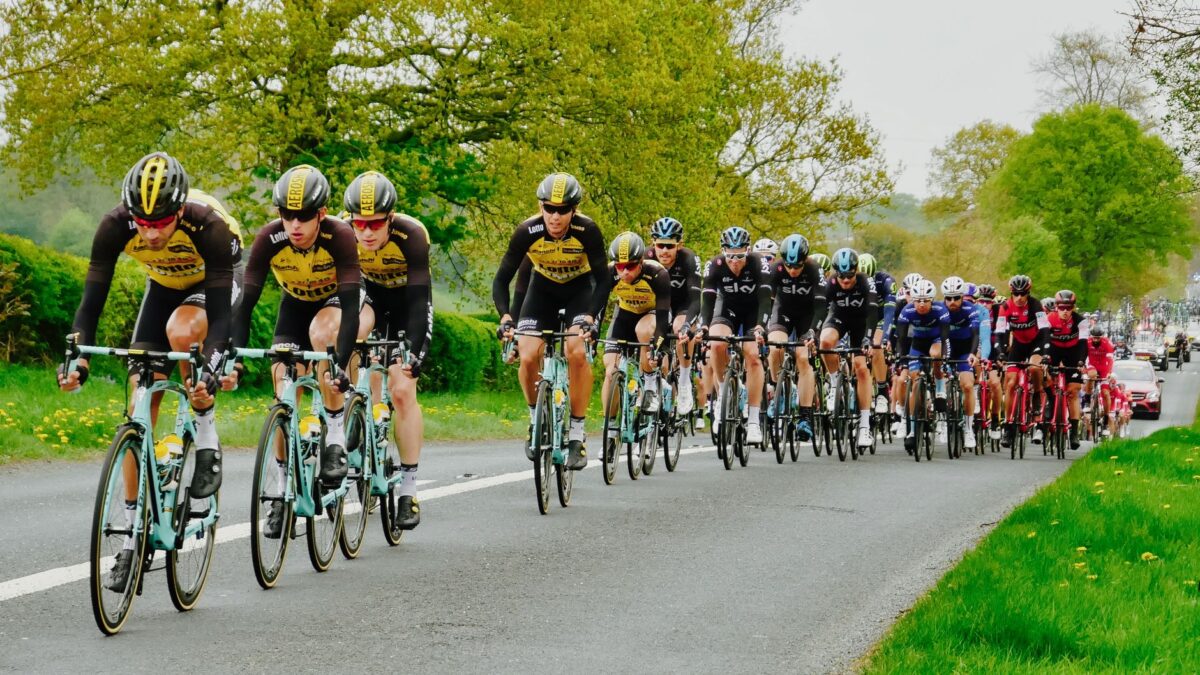 Cyclists competing in a professional race through picturesque Knaresborough, England.